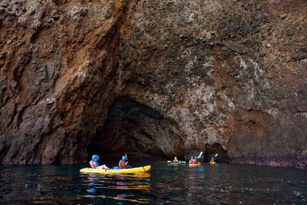 kayakers at the painted caves at the islands
