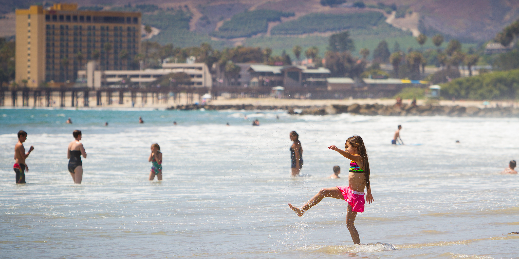 Little girl splash ocean beach Ventura