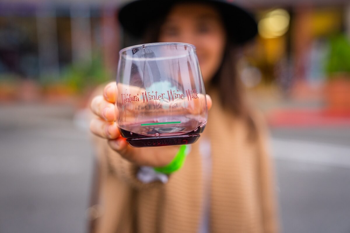 girl holding glass at wine walk