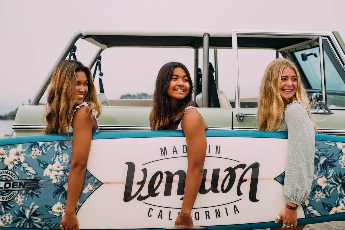 girls holding the ventura surfboard