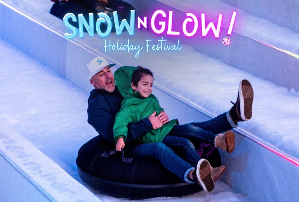 Father and son tubing on a slide with snow