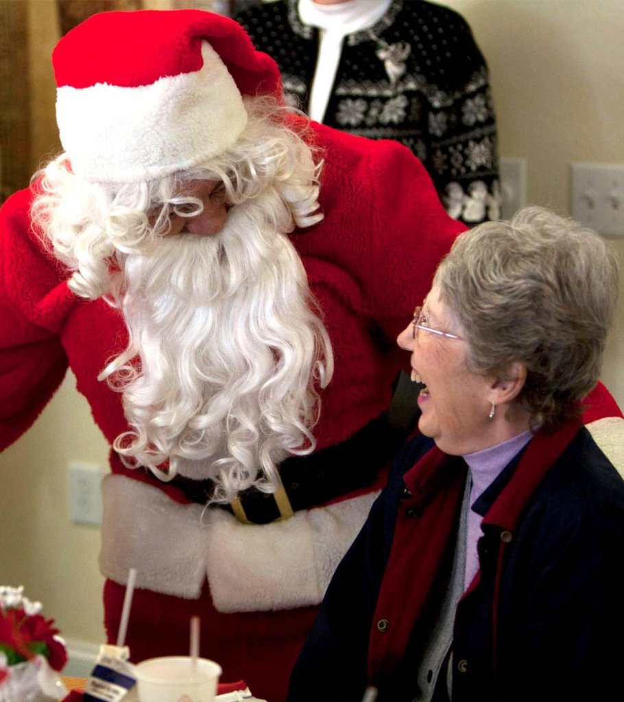 Santa talking to a laughing elderly woman
