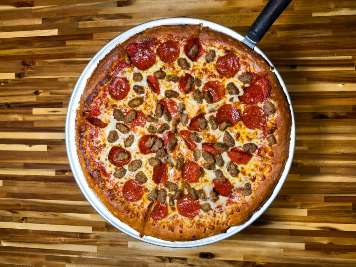 Top down view of a pepperoni and sausage pizza at Pizza Station in Ventura California